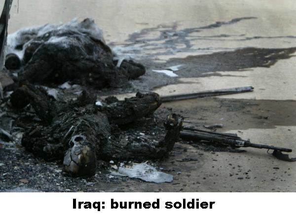 DEAD IRAQI SOLDIERS LAY BESIDE A DESTROYED BUS ON A HIGHWAY NEAR BAGHDAD
